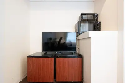 a flat screen tv sitting on top of a wooden cabinet at Shibuya Station 8-min walk, Shibuya Center, 3 people stay, WIFI, 4F No elevetor in Tokyo