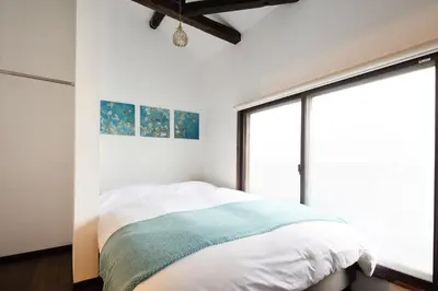 a bedroom with a bed and a large window at \u548c\u6c23\u4f1a\u3005\u6d45\u8349\u6a4b Wakiaiai Asakusabashi in Tokyo