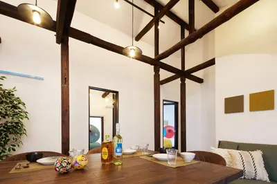 a dining room with a wooden table and chairs at \u548c\u6c23\u4f1a\u3005\u6d45\u8349\u6a4b Wakiaiai Asakusabashi in Tokyo