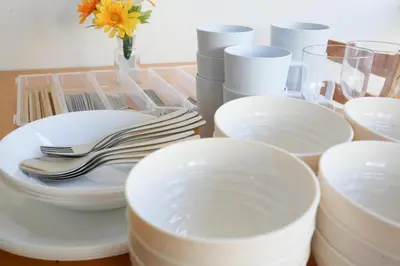 a table with white plates and utensils on a table at Full facilities 9PPL CozyHouse1 stop-Yamanote Line in Tokyo
