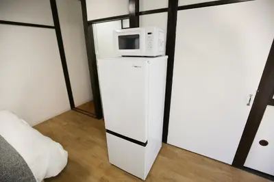 a microwave sitting on top of a refrigerator at Full facilities 9PPL CozyHouse1 stop-Yamanote Line in Tokyo