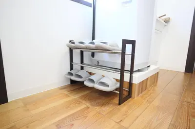 a group of white shoes on a shelf in a room at Full facilities 9PPL CozyHouse1 stop-Yamanote Line in Tokyo