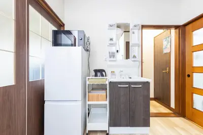 a kitchen with a refrigerator and a sink at nagomi\u5eb5 in Tokyo