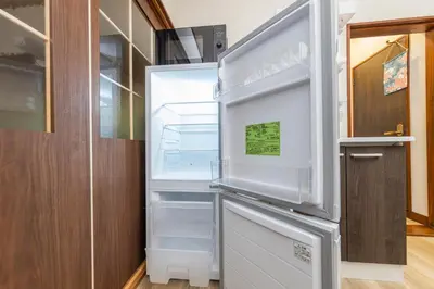 an empty refrigerator with its door open in a kitchen at nagomi\u5eb5 in Tokyo
