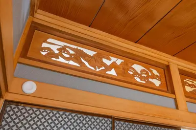 a wooden door with intricate carvings on it at nagomi\u5eb5 in Tokyo
