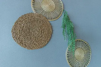 three wicker hats hanging on a wall at nagomi\u5eb5 in Tokyo