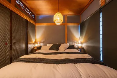 a bedroom with a large bed with lights on it at nagomi\u5eb5 in Tokyo
