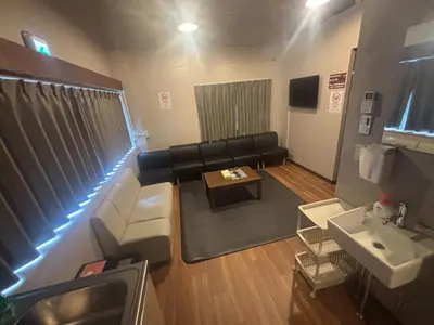 a living room with a couch and a table at Hinode Kagurazakaekimae Hotel in Tokyo