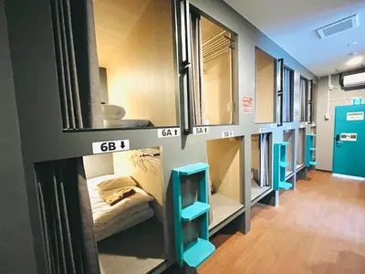 a room with a bunch of bunk beds in it at Hinode Kagurazakaekimae Hotel in Tokyo