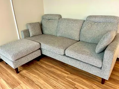 a couch and a chair in a room at Hinode Kagurazakaekimae Hotel in Tokyo