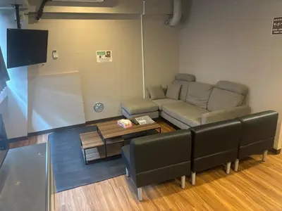 a living room with a couch and a table at Hinode Kagurazakaekimae Hotel in Tokyo
