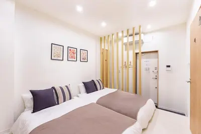 a white bedroom with a large bed in it at \u6953\u5c4b1F 120Ta in Tokyo