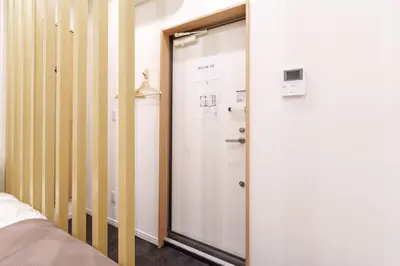 a sliding glass door in a room with a bed at \u6953\u5c4b1F 120Ta in Tokyo