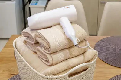 a hair dryer sitting on top of towels on a table at \u6953\u5c4b1F 120Ta in Tokyo