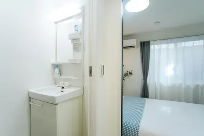 a white bathroom with a sink and a shower at Near Asakusa and Ueno, Spacious 3BR House, Max 8 People in Tokyo