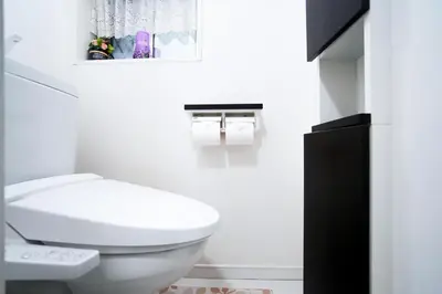 a bathroom with a white toilet and a black cabinet at Near Asakusa and Ueno, Spacious 3BR House, Max 8 People in Tokyo