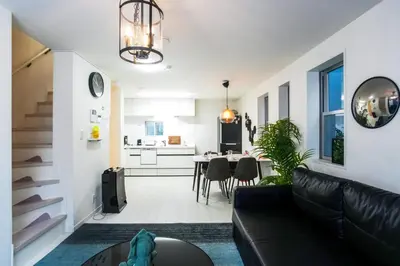 a living room with a couch and a dining room at Near Asakusa and Ueno, Spacious 3BR House, Max 8 People in Tokyo