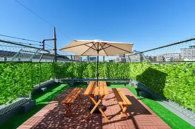 a picnic table with an umbrella on a patio at \u6953\u5c4b\u30a2\u30cd\u30c3\u30af\u30b9 120Tb in Tokyo
