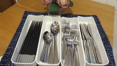 a table with silver utensils on a table at Y's INN Ikebukuro 013T in Tokyo