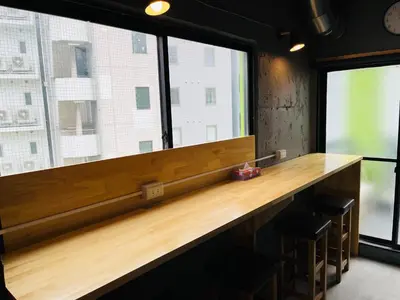 a counter in a room with a large window at Mikami Asakusabashi Hotel in Tokyo
