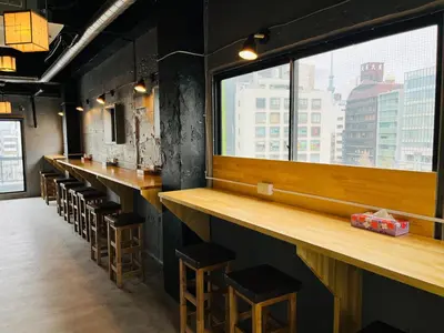 a bar with stools and a large window at Mikami Asakusabashi Hotel in Tokyo