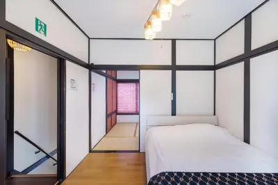 a bedroom with a bed and glass walls at \u5927\u718a\u306e\u5bb6 028t in Tokyo