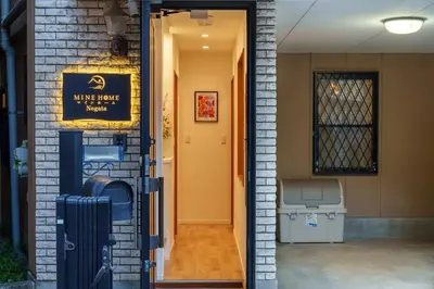 a door to a house with a sign on it at MINE HOME\u91ce\u65b9 121t in Tokyo