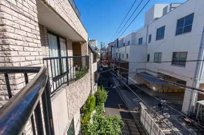 a view of a street from a balcony of a building at MINE HOME\u91ce\u65b9 121t in Tokyo