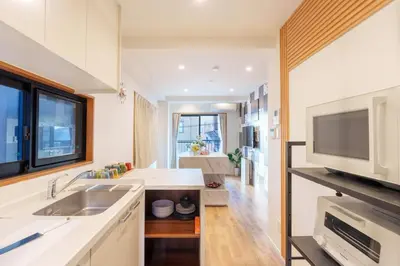a kitchen with a sink and a microwave at MINE HOME\u91ce\u65b9 121t in Tokyo
