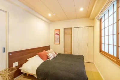 a bedroom with a large bed and a window at MINE HOME\u91ce\u65b9 121t in Tokyo