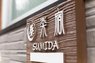a sign on a building that says sunda at \u697d\u5bbfSUMIDA 002t in Tokyo