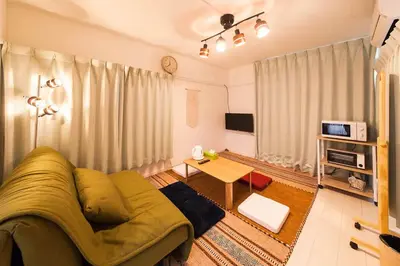 a living room with a couch and a tv at \u697d\u5bbfSUMIDA 002t in Tokyo