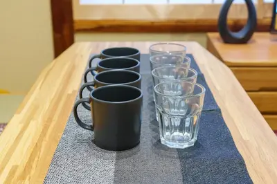 a row of glasses sitting on a table at Y's INN 押上 115T in Tokyo