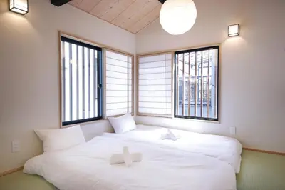 a large white bed in a room with windows at \u5922\u306e\u5929\u7a7a\u6a39 027t in Tokyo