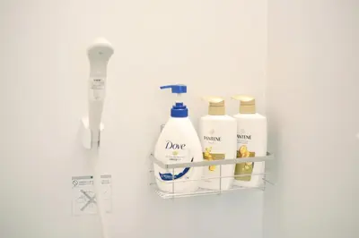 a shelf with three bottles of soap and a toothbrush at \u5922\u306e\u5929\u7a7a\u6a39 027t in Tokyo