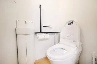 a white bathroom with a toilet and a refrigerator at \u5922\u306e\u5929\u7a7a\u6a39 027t in Tokyo