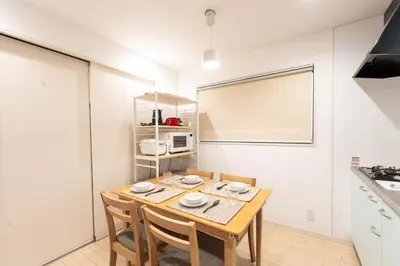 a dining room with a table and chairs in a kitchen at 132T close \u5922\u306e\u5bbf \u7ffc in Tokyo