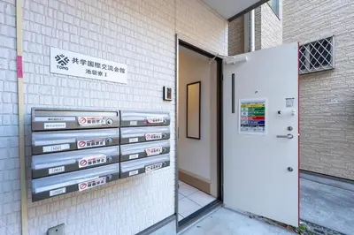a sign on the side of a building next to a door at 132T close \u5922\u306e\u5bbf \u7ffc in Tokyo