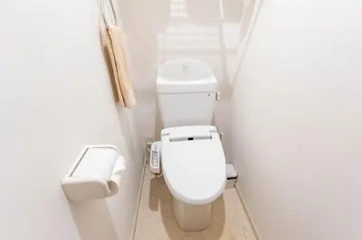 a small bathroom with a white toilet in a stall at 132T close \u5922\u306e\u5bbf \u7ffc in Tokyo