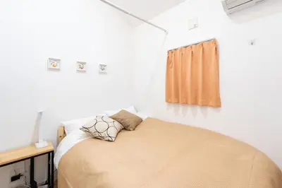 a bedroom with a bed and a window at 132T close \u5922\u306e\u5bbf \u7ffc in Tokyo