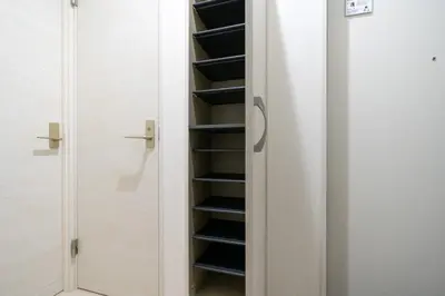 a closet with black shelves and a glass door at \u30a2\u30fc\u30d0\u30f3\u30b3\u30fc\u30c8\u62bc\u4e0a in Tokyo
