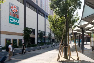 people walking on a sidewalk in front of a building at \u30a2\u30fc\u30d0\u30f3\u30b3\u30fc\u30c8\u62bc\u4e0a in Tokyo