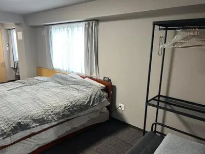 a bedroom with a bunk bed and a window at Haneda Base in Tokyo