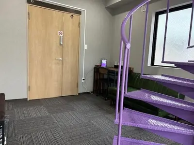 a room with purple purple bunk beds and a door at Haneda Base in Tokyo