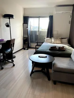 a bedroom with a bed and a table and a couch at \u7af9\u30ce\u585a \u30d7\u30ec\u30df\u30a2 in Tokyo