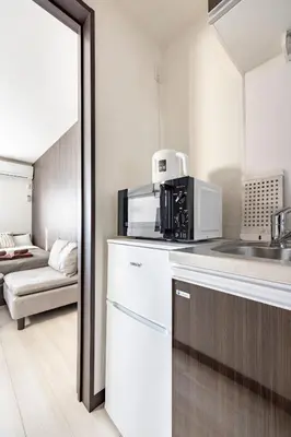 a kitchen with a sink and a microwave at \u7af9\u30ce\u585a \u30d7\u30ec\u30df\u30a2 in Tokyo