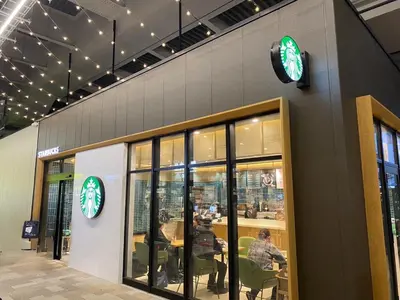 a restaurant with a clock on the side of a building at \u7af9\u30ce\u585a \u30d7\u30ec\u30df\u30a2 in Tokyo
