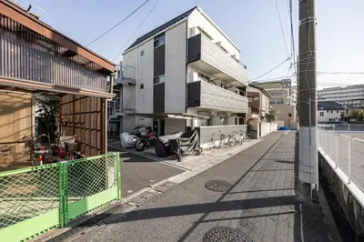 a building with a motorcycle parked on a street at \u7af9\u30ce\u585a \u30d7\u30ec\u30df\u30a2 in Tokyo