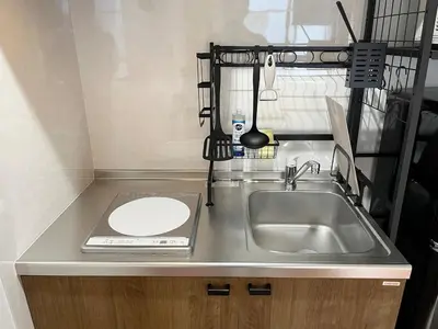 a kitchen counter with a sink and a plate on it at jtr\u6d45\u8349\u6a4b302 in Tokyo