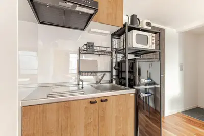 a kitchen with a sink and a microwave at jtr\u6d45\u8349\u6a4b302 in Tokyo